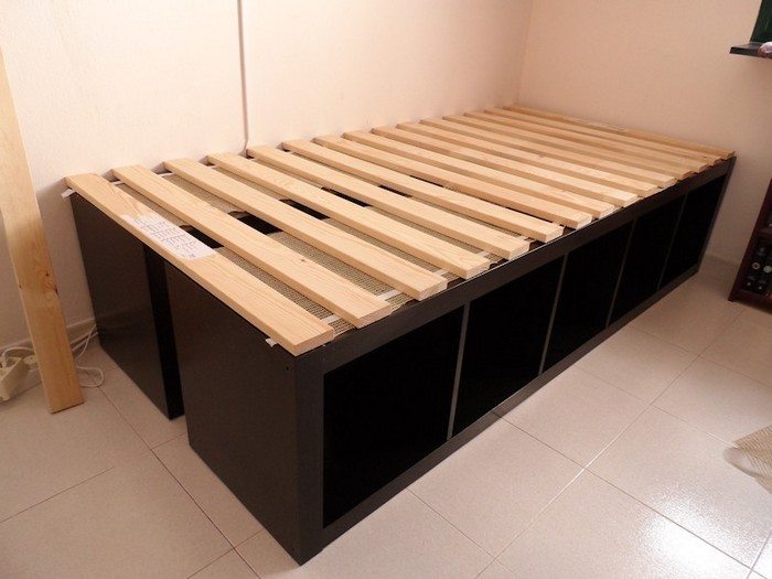 Build an inexpensive bed with storage using bookcases 