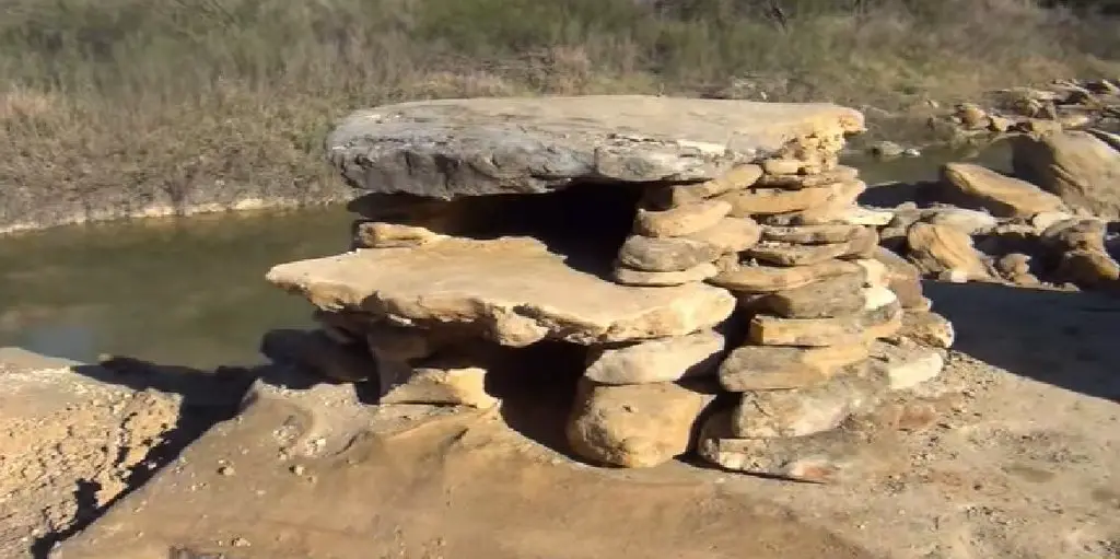 An outdoor oven made by stacking rocks and stones.