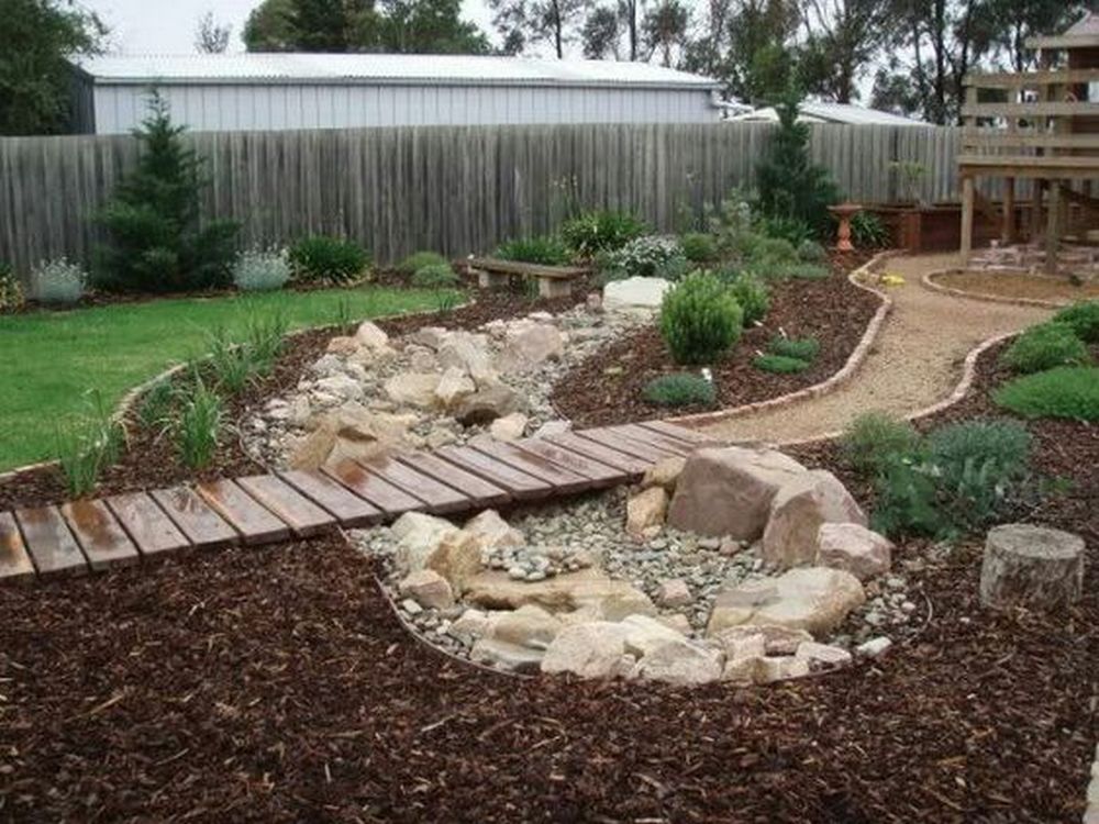 This DIY dry creek bed project is both functional and aesthetically appealing.