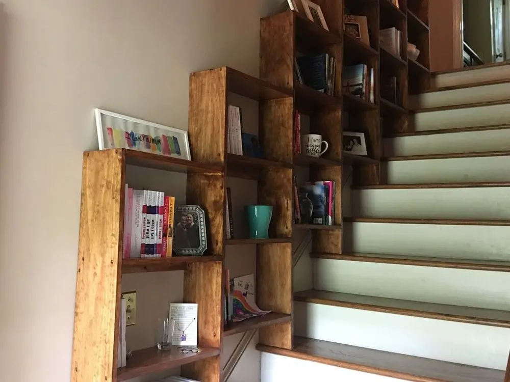 Make good use of that empty stairway space and build a staircase bookshelf in them!