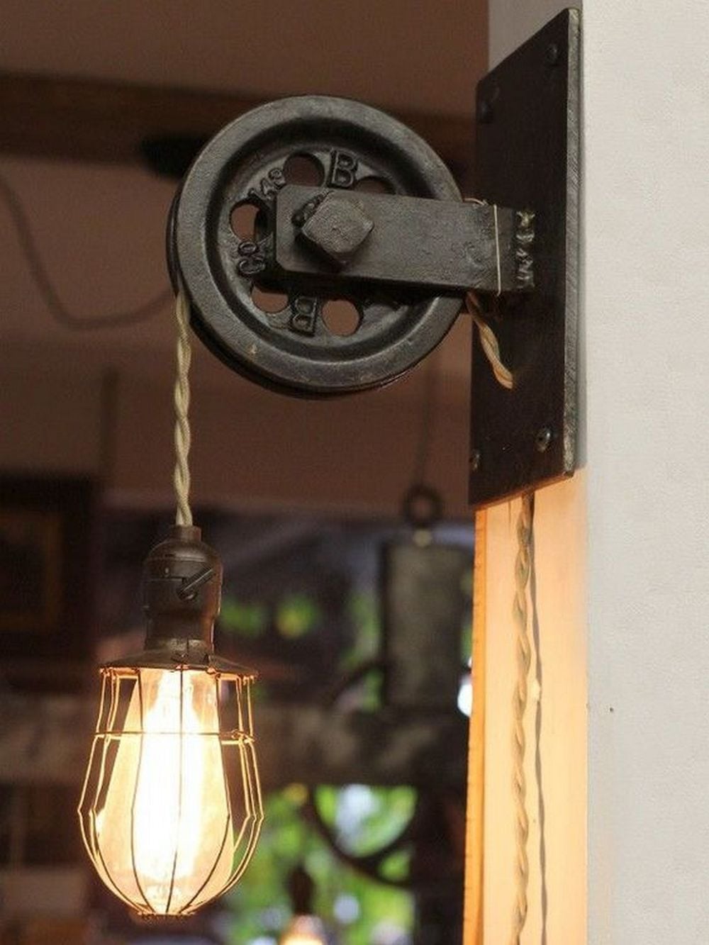 This vintage-style pulley lamp will add character to any room you put it in.