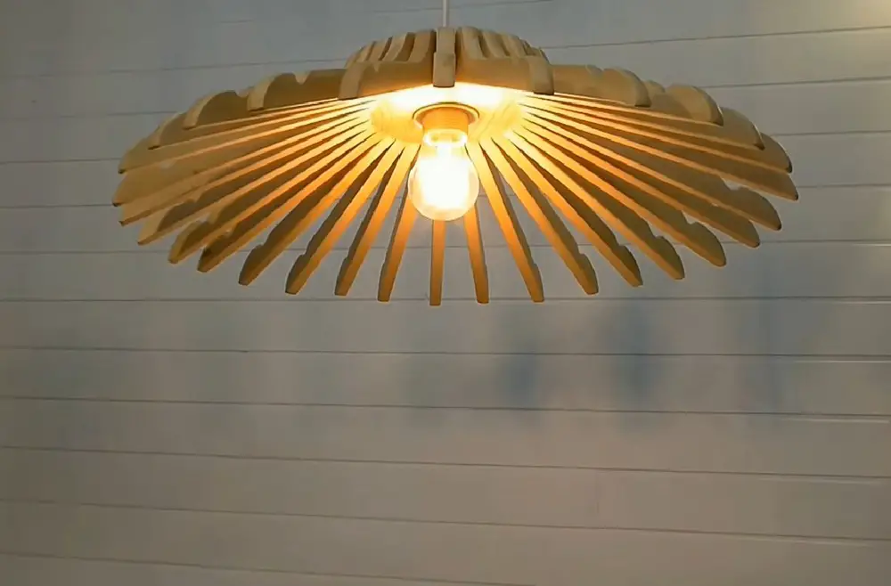Unique and very appealing, this DIY wooden hangers lamp is truly a worthwhile project.