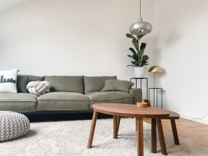 An image of a grey couch with white walls for an article about "minimalist modern living room ideas."