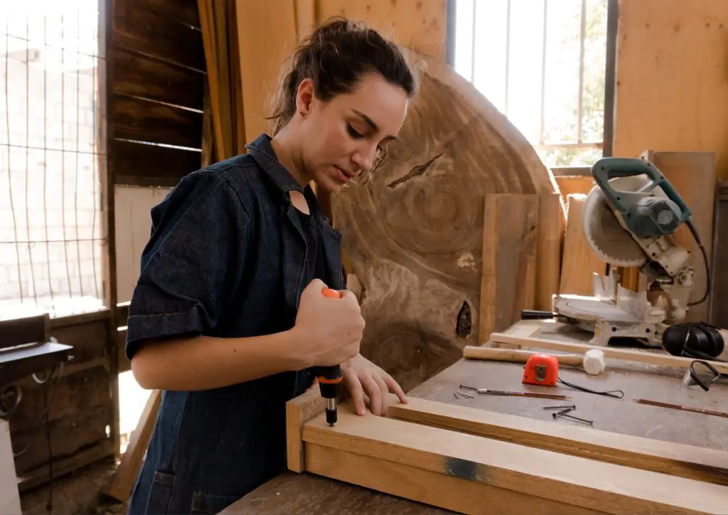 A woman doing a woodworking project.