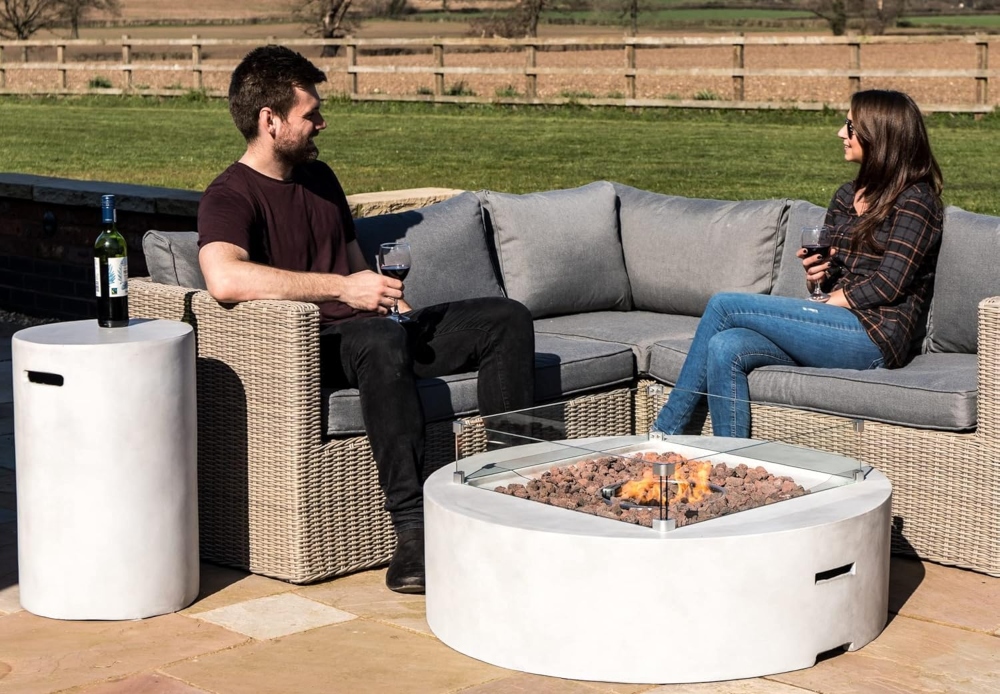 An image of people around a propane fire pit.