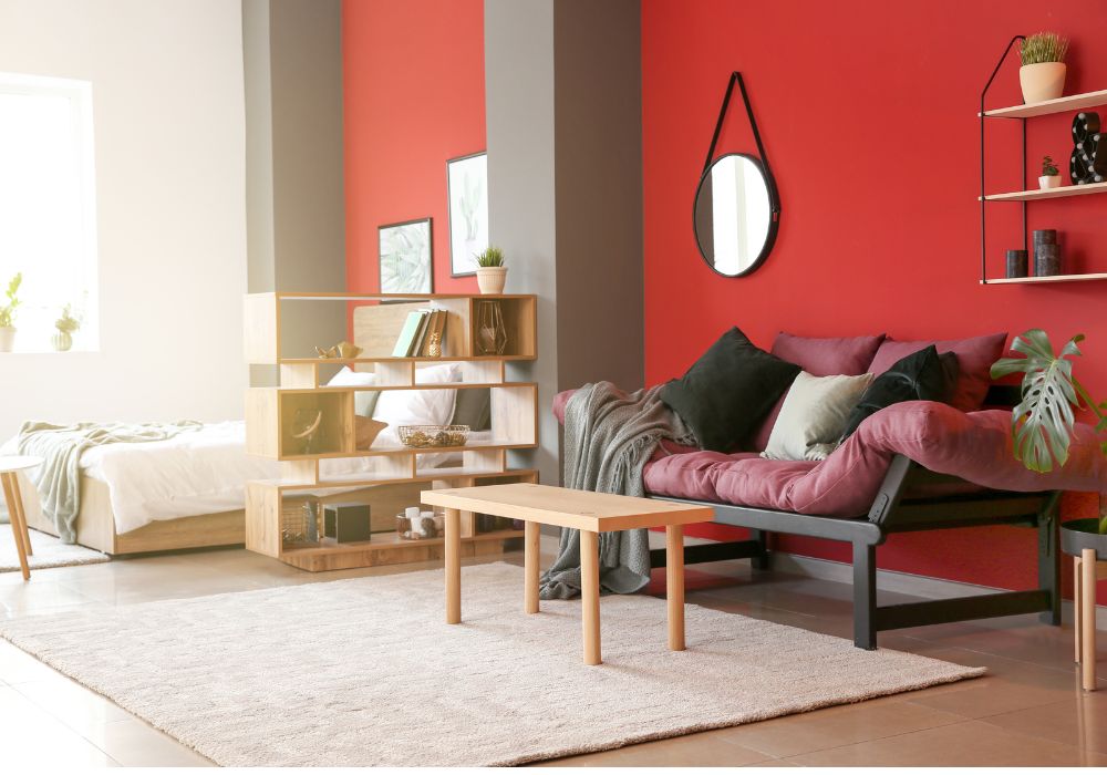 Incorporating a shade of red to the couch that matches the wall color. 